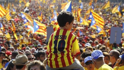 A little boy in a Lionel Messi shirt attends a Catalonia National Day celebration in Barcelona on September 11, 2014. Quique Garcia / AFP