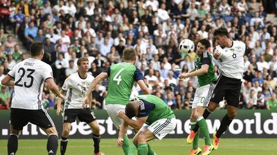 Germany's Sami Khedira, right, jumps for the ball with Northern Ireland's Craig Cathcart during the Euro 2016 Group C soccer match between Northern Ireland and Germany at the Parc des Princes stadium in Paris, France, Tuesday, June 21, 2016. (AP Photo/Martin Meissner)