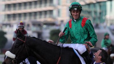 Cristophe Soumillon on his Vazirabad is congratulated by his staff after winning the Dubai Gold Cup race as part of the Dubai World Cup day horse racing event on March 26, 2016 at the Meydan racecourse in the United Arab Emirate of Dubai. Closing the UAE racing season, the Dubai World Cup day features nine races including the world’s richest horse race, the ten million US dollars Dubai World Cup. / AFP / MARWAN NAAMANI