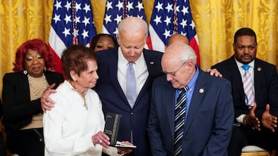 Mr Biden embraces the parents of Officer Sicknick as he presents presents them with his posthumous medal. Reuters