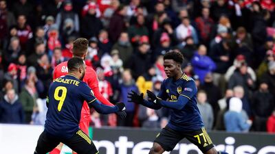 Arsenal's Bukayo Saka, right, celebrates after scoring the equaliser during the Europa League match against Standard Liege in Belgium. EPA