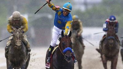 Victor Espinoza, centre, celebrates aboard American Pharoah after winning the 140th Preakness Stakes horse race at Pimlico Race Course on May 16, 2015. Patrick Semansky / AP Photo