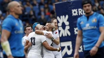 England centre Jonathan Joseph celebrates with teammates after scoring a try against Italy in Rome last year. Riccardo De Luca / Getty Images