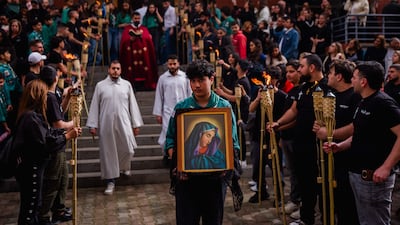 A scout carries the icon of the Virgin Mary during a Good Friday procession near the Saint Maroun Church in the Shiyah neighbourhood of Beirut's southeastern suburbs. AFP