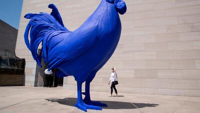 A visitor looks at a large sculpture entitled 'Hahn/Cock', by German-born artist Katharina Fritsch, on the first day of the reopening to the public of the National Gallery of Art's East Building, in Washington, DC, US. EPA