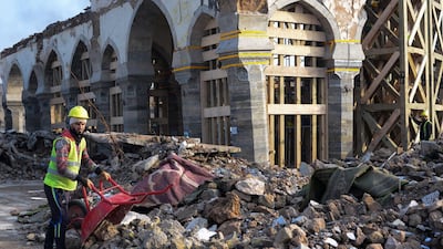 An Iraqi worker clears rubble during the reconstruction of the Great Mosque of Al-Nuri in Mosul’s war-ravaged old town. AFP