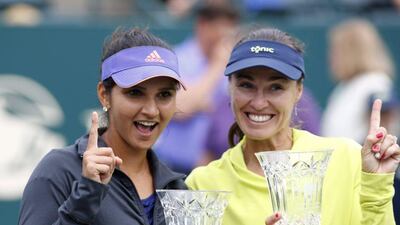 Sania Mirza, left, alongside doubles partner Martina Hingis after winning the Family Circle Cup tournament that propelled her to World No 1. Mic Smith / AP Photo