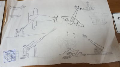 Most of the drawings, in pencil or crayon, depict fierce battles in open fields, at sea or in cities. Sinan Mahmoud / The National