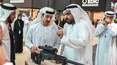 Sheikh Hazza bin Zayed, Deputy Chairman of Abu Dhabi Executive Council, inspects the CSR 50 sniper rifle with EDIC's business development director Hamad Al Ameri. Victor Besa / The National