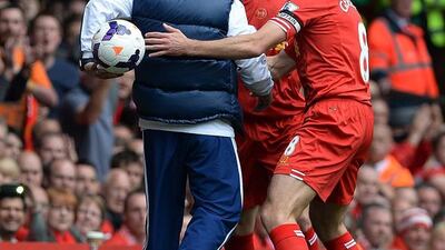 Chelsea manager Jose Mourinho, left, keeps the ball from Liverpool’s Steven Gerrard, right, during the English Premier League soccer match between Liverpool and Chelsea played at Anfield, Liverpool, Britain, 27 April 2014. EPA/PETER POWELL
