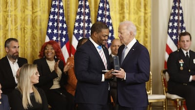 Eugene Goodman, a Capitol police officer, receives the Presidential Citizens Medal from Mr Biden. Bloomberg