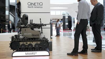 Visitors look at the unmanned ground vehicle at the Qinetiq North America stand on the first day of the UMEX held at ADNEC in Abu Dhabi. Pawan Singh / The National