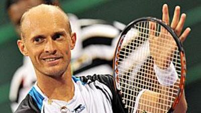 Nikolay Davydenko acknowledges the crowd after the win over Rafael Nadal in Doha.