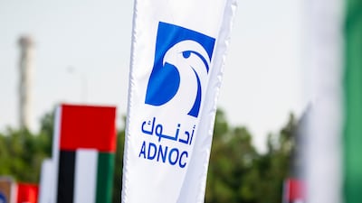 The Adnoc logo and UAE flags at the Habshan Complex