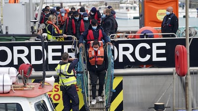 A group of people thought to be migrants are brought in to Dover, Kent, following a small boat incident in the Channel. PA
