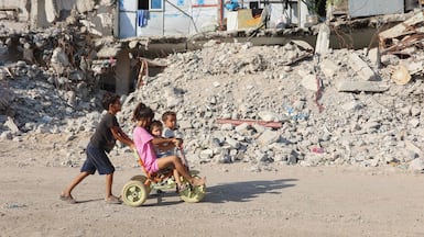 Palestinian children play near the rubble of destroyed buildings in Gaza city. AFP