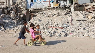 Palestinian children play near the rubble of destroyed buildings in Gaza city. Israel launched deadly strikes across the strip on Sunday. AFP