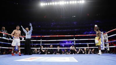 The referee stops the fight during the sixth round when England's Amir Khan could not continue after a low blow by Terence Crawford. AP Photo