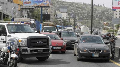 Lebanese security forces stop vehicles north of Beirut as authorities implemented further measures restricting the movement. AFP