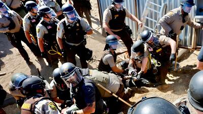 Police arrest environmental activists at the Line 3 pipeline pumping station near the Itasca State Park in Minnesota, the US. A proposed new route for the pipeline has sparked resistance from climate justice groups. AFP