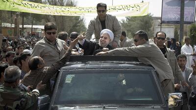 Iranian President Hassan Rouhani greets supporters after his arrival in Zahedan, the regional capital of Sistan and Baluchestan province on Tuesday, April 15, 2014. During Mr Rouhani's two-day visit, he will tour several other cities and hold meetings with local scholars and entrepreneurs. Maryam Rahmanian for The National