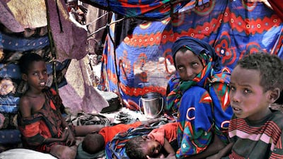 July 25 2011: Somalis displaced by drought wait in their makeshift shelter in Mogadishu. Some thousands of people have arrived in Mogadishu seeking aid and The World Food Program executive director Josette Sheeran said Saturday they can't reach the estim???