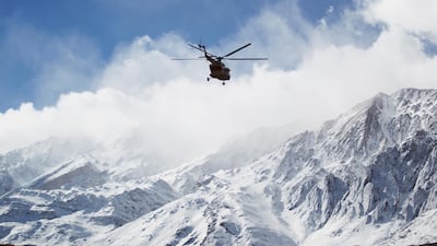 A rescue helicopter flies over the Dena mountains while searching for the wreckage of a plane that crashed in southern Iran. The [;an was located, a military spokesman said. Ali Khodaei / Tasnim News Agency via AP