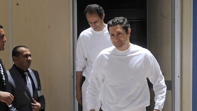 Gamal, left, and Alaa Mubarak, right, arrive to the police academy courthouse in Cairo, Egypt on June 2, 2012. Egyptian security officials say the two sons of ex-president Hosni Mubarak have been released from prison, nearly four years after they were first arrested along with their father. AP Photo / File