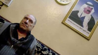 Muayed Abdulkadir, editor of the Iraqi resistance newspaper Al Saut, sits in his office in Damascus with a poster of Saddam Hussein on the wall.