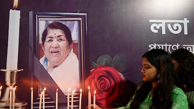 People pay tribute to Indian singer Lata Mangeshkar in Kolkata on Sunday, after she died at the age of 92. AFP