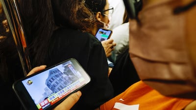 A passenger on a Taipei subway train watches a news report about the earthquake. EPA
