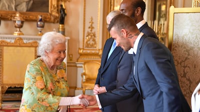 Queen Elizabeth meets former England footballer David Beckham at Buckingham Palace. Getty