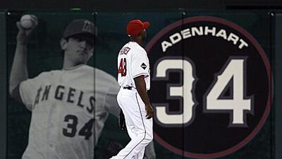The Los Angeles Angels centre fielder Torii Hunter takes his position in front of an image of former teammate Nick Adenhart.