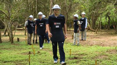England wicketkeeper-batsman Jonny Bairstow, in front, and Olly Stone fitted out with de-mining personal protective equipment on a tour of a previously cleared area of mine site during the England cricket team's visit to a de-mining event held by MAG on Monday in Periyamadu. Getty Images