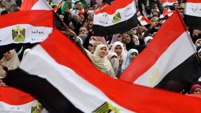 Egyptian women wave flags during a rally in Cairo's Tahrir Square on Friday in a protest against what they say are attempts by the country's military rulers to avoid any control by a civilian government.