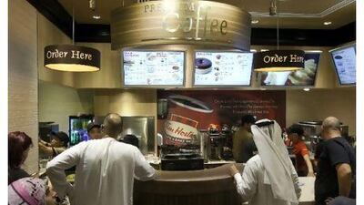 Customers wait in line at Tim Hortons coffee shop in Dubai, the first to open in the UAE. Pawel Dwulit / The National