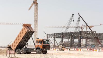 A lorry tips its load near the Structure that will be the Metro station next to the main part of the site.