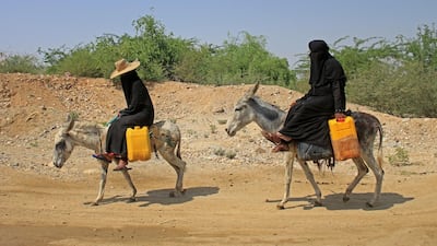 Yemeni women commute on donkeys carrying jerrycans of water at a camp for internally displaced people by conflict in the northern Hajjah province. AFP