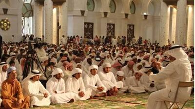 A sermon is presented in sign language for hearing impaired visitors at Sheikh Zayed Grand Mosque.