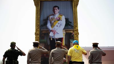 Thailand's Prime Minister Prayut Chan-O-Cha, Royal Thai Army Commander-in-Chief Apirat Kongsompong and others salute in front of a portrait of King Maha Vajiralongkorn in Lopburi. AFP