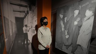 Lee-Jane Yates who served as a WPC at Bow Street Police Station from 1982-1985, looks at old photographs in the new Bow Street Police Museum. AP Photo/Kirsty Wigglesworth.