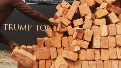 An Indian labourer works on the road leading to the under-construction Trump Tower in Kolkata. Dibyangshu Sarkar / AFP
