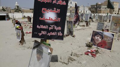 Tributes recalll the victims of a suicide bombing of a Shia mosque, at a cemetery in al-Qudeeh, Saudi Arabia. (AP Photo/Hasan Jamali)