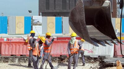 Workers are seen at a construction site in Doha on November 16, 2014. AFP Photo