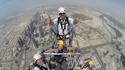 On top of Burj Khalifa: Support staff Chris Hughes, Megarme, top centre; platform designer Andy Veal, WSP, centre; Daniel Eede, Megarme operations manager, left; Jayson, Megarme level 3 supervisor, with blue scarf; and Billy, Megarme level 2 supervisor, wearing orange webbing. Photo courtesy Skydive Dubai; Daniel Eede, Megarme