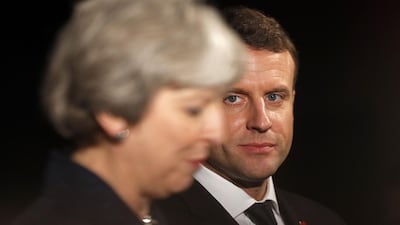 French President Emmanuel Macron (R) and Britain's Prime Minister Theresa May at an event at the Victoria and Albert museum in central London. Adrian Dennis / AFP