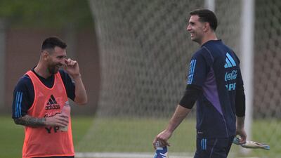 Argentina forward Lionel Messi shares a joke with goalkeeper Emiliano Martinez. AFP