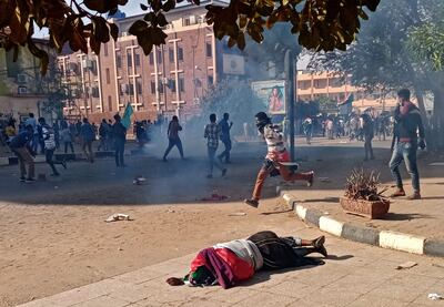 A protester lies wounded on the ground after security forces fired tear gas at demonstrators at an anti-military rally in Sudan's capital Khartoum. AFP