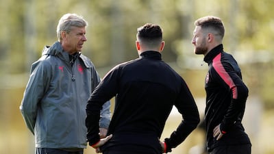 Arsene Wenger talks to Sead Kolasinac with Shkodran Mustafi during training ahead of Arsenal's Europa League opener against Cologne. John Sibley / Reuters