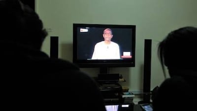 Dakar TV viewers watch the singer Youssou Ndour announce his candidacy in Senegal's presidential election.